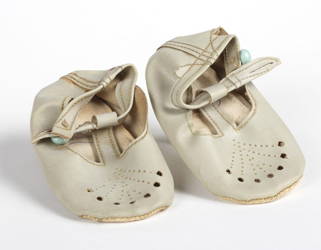 Cheshire poet Adam Johnson’s baby shoes made of cream leather with a button clasp, dating from the 1960s.