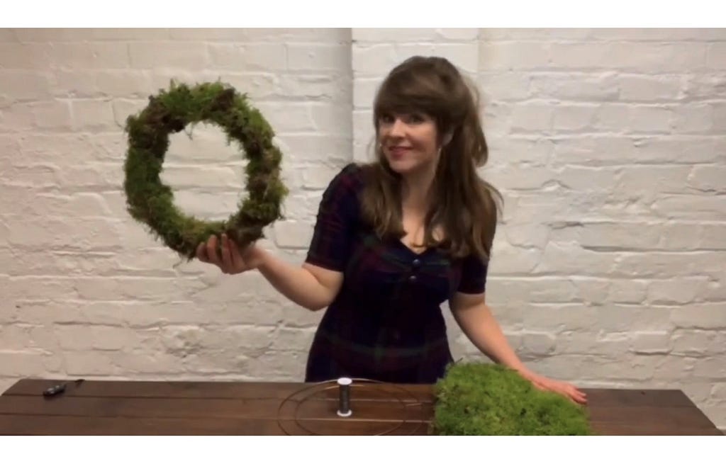 Jen Baker of Lavender Blue Florist holds wreath base made of moss