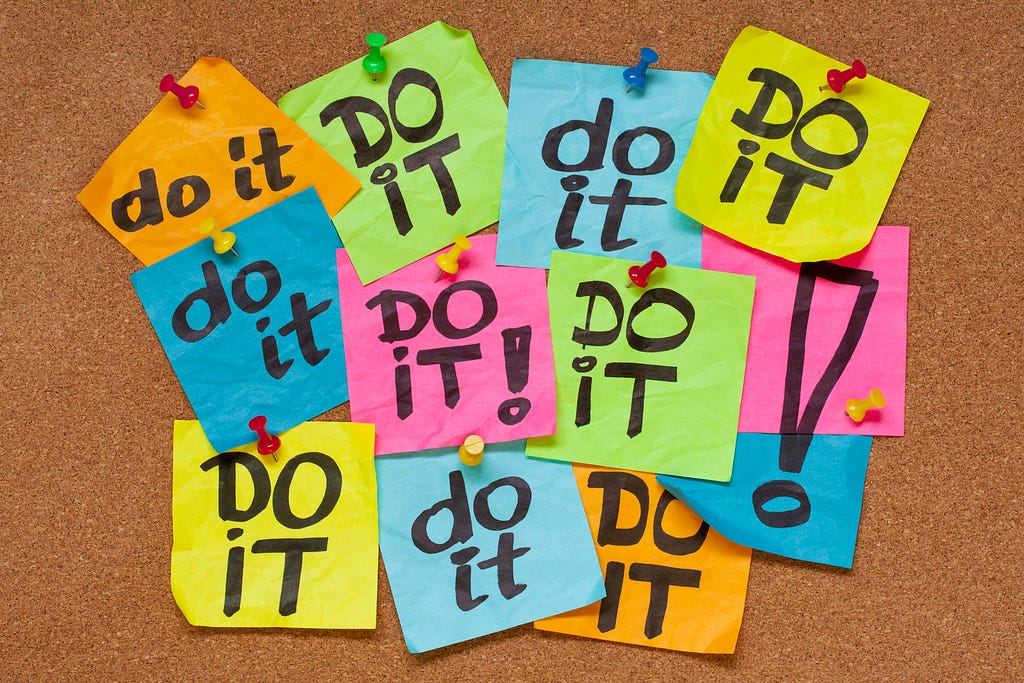 Post-it notes with the phrase “Do it” on a bulletin board