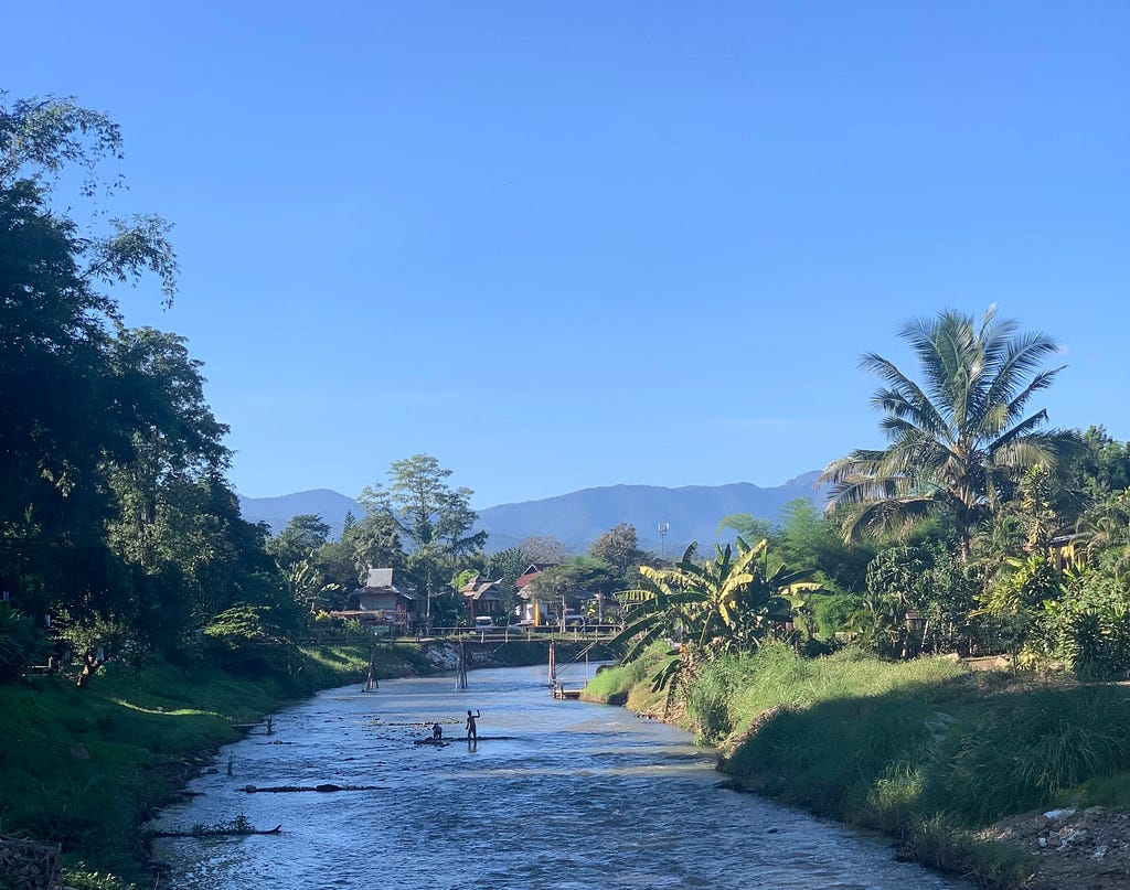 The Pai River, set against a mountain backdrop and blue sky