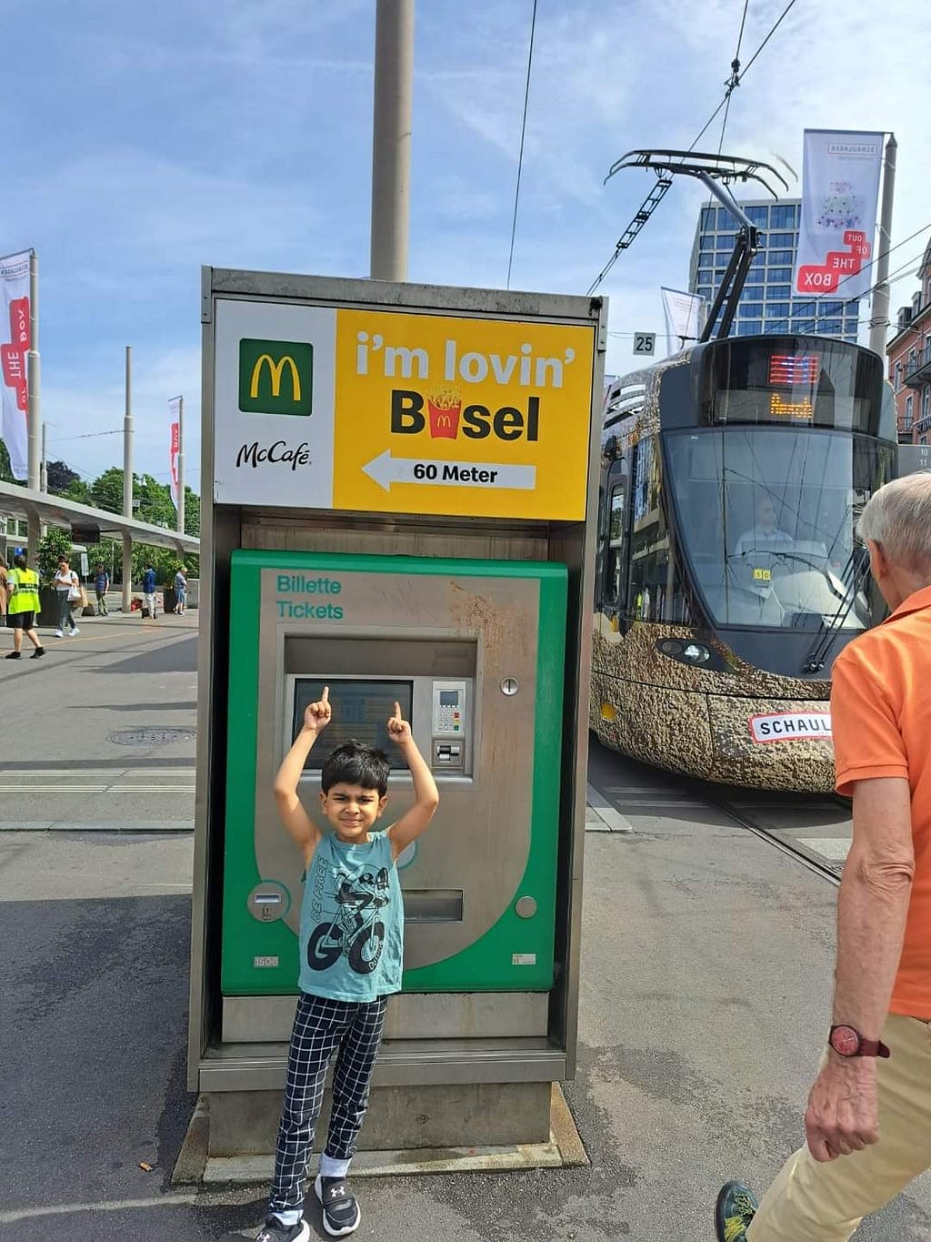 A small boy standing on a train station at Basel, Switzerland