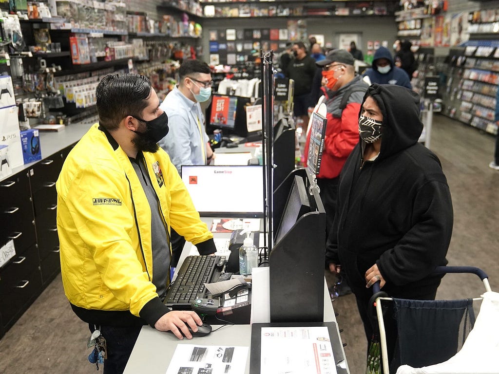 Inside a GameStop store people line up to purchase a Sony PS5 gaming console in New York City.