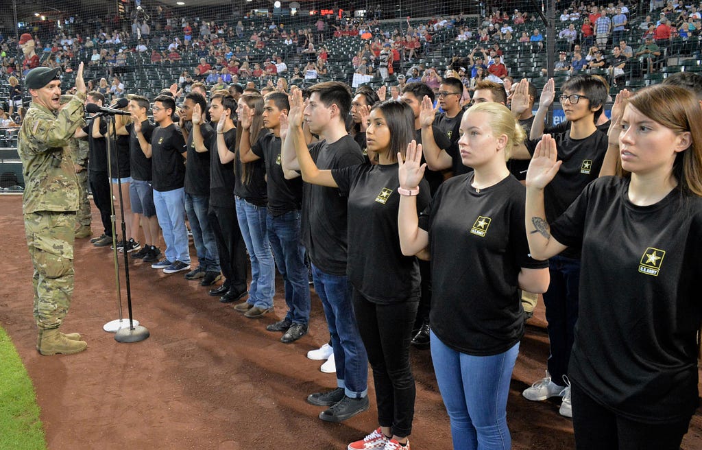 Lt. Col. Scott Morley, commander of the Phoenix Recruiting Battalion, administers the oath of enlistment to 40 future soldiers, August 26, 2018, at Chase Field. Photo by Mike Scheck/U.S. Army