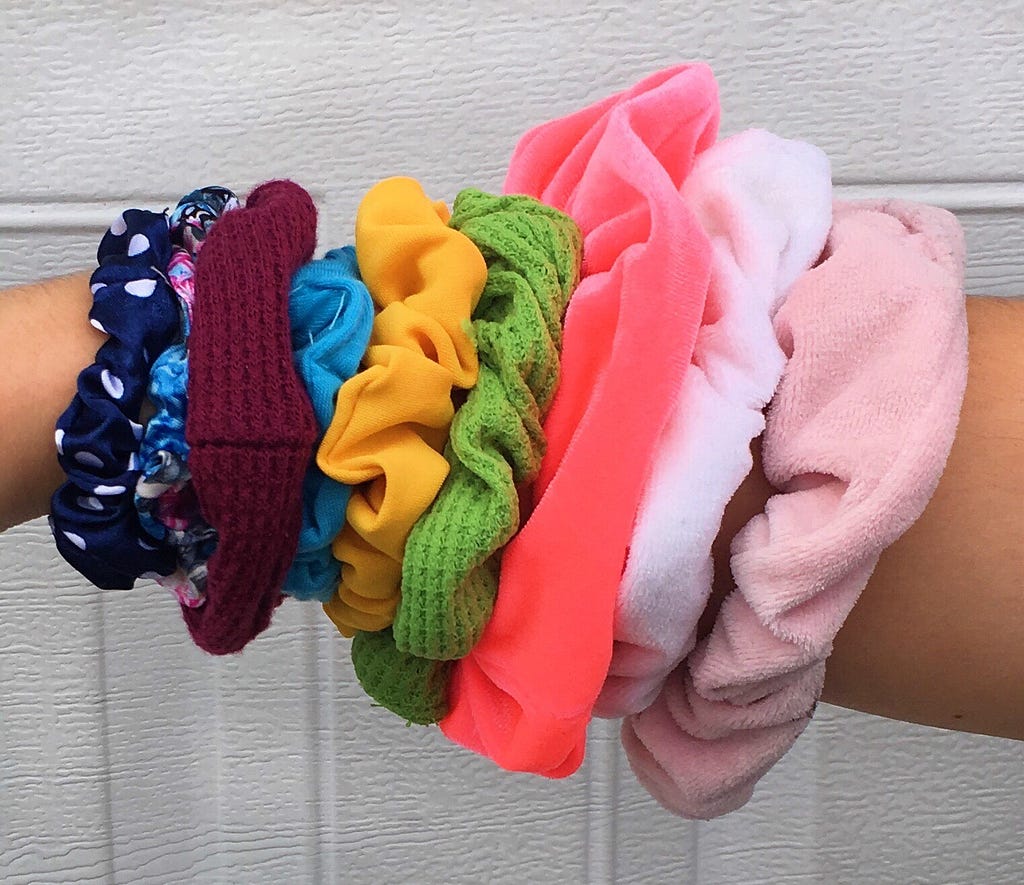 Nine scrunchies on my wrist. Each a different, vibrant color.