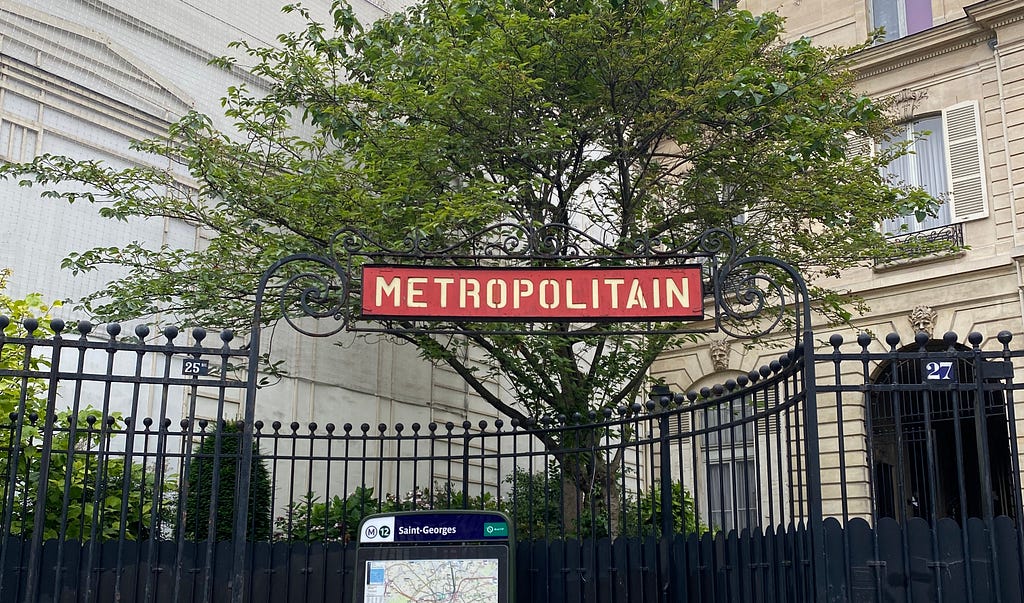 Paris Métro entrance: the well recognised Metropolitain red signage.