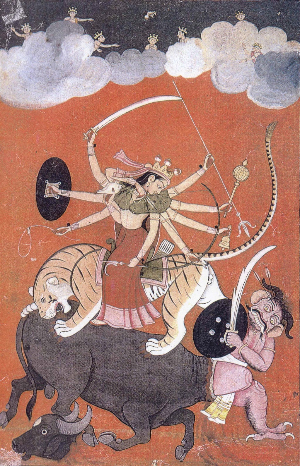 ancient depiction of Durga riding a tiger and fighting a demon