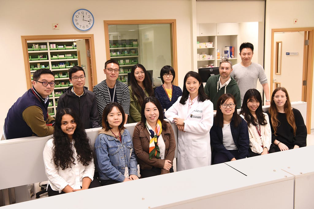 Dr Esther Chan Wai-yi stands in the middle of her team who’s working on anticoagulation medicine.