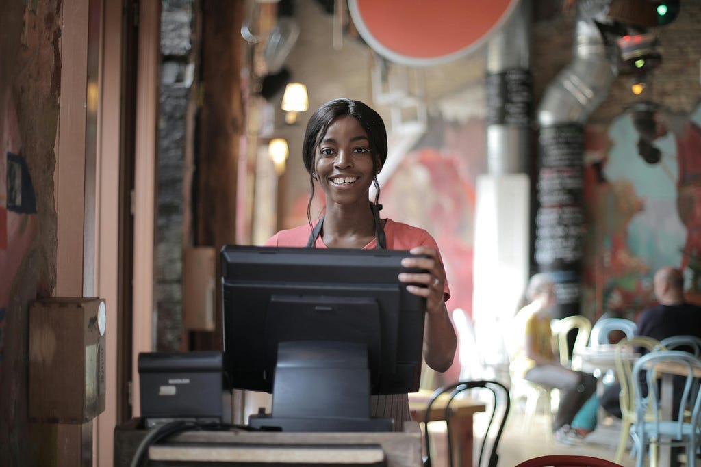 A business owner standing at the counter and smiling: dropshipping