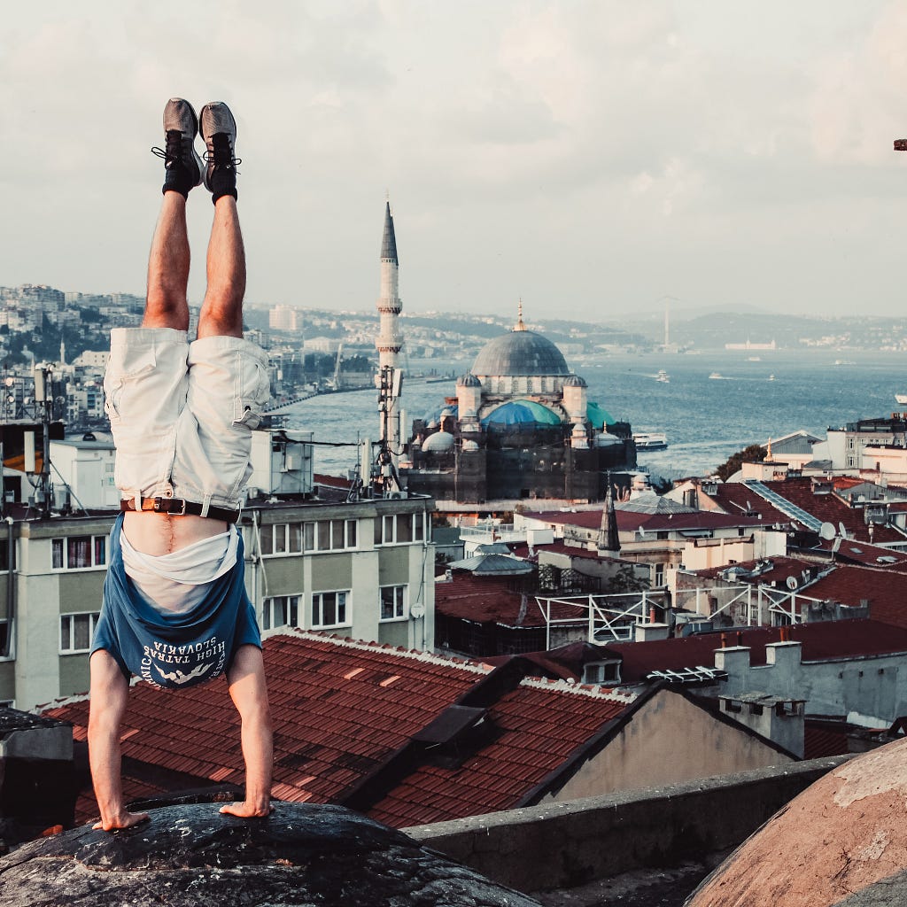 How to instantly improve your handstand final image. The author in a handstand on the edge of a building in Istanbul, Turkey.