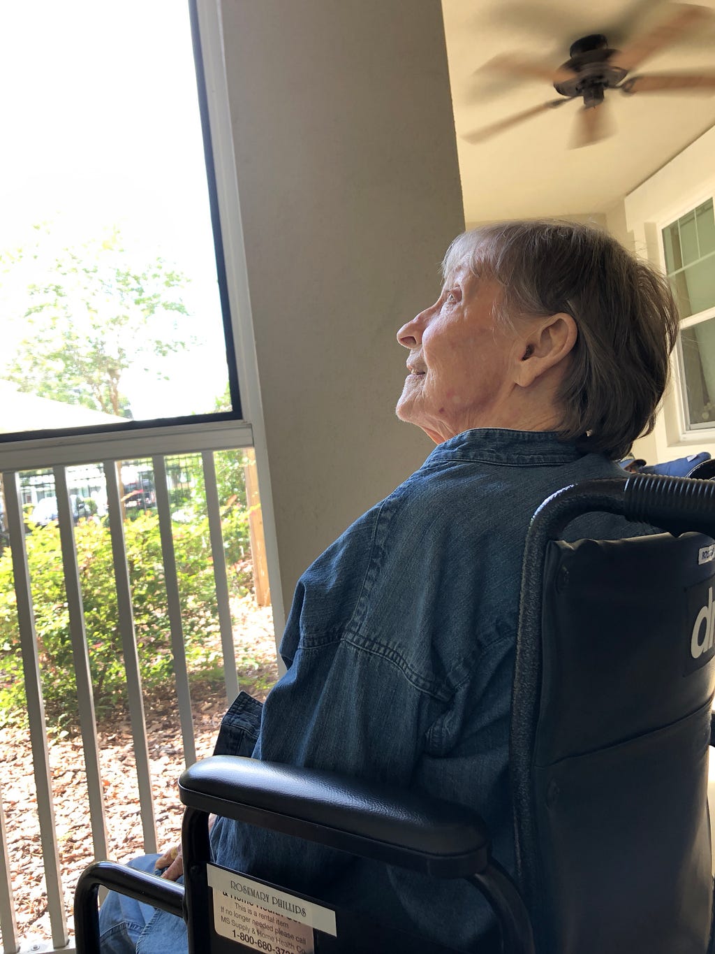 My mom enjoying some time on the porch at her memory care home