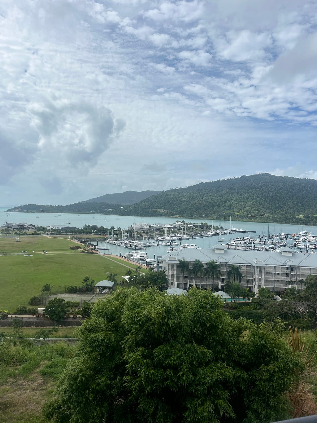 Panoramic view from balcony at Whitsunday Terraces showcasing marina and bay, offering breathtaking scenery of Airlie Beach, Queensland, Australia