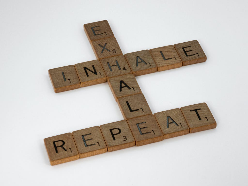 Scrabble tiles spelling out Inhale, Exhale, Repeat