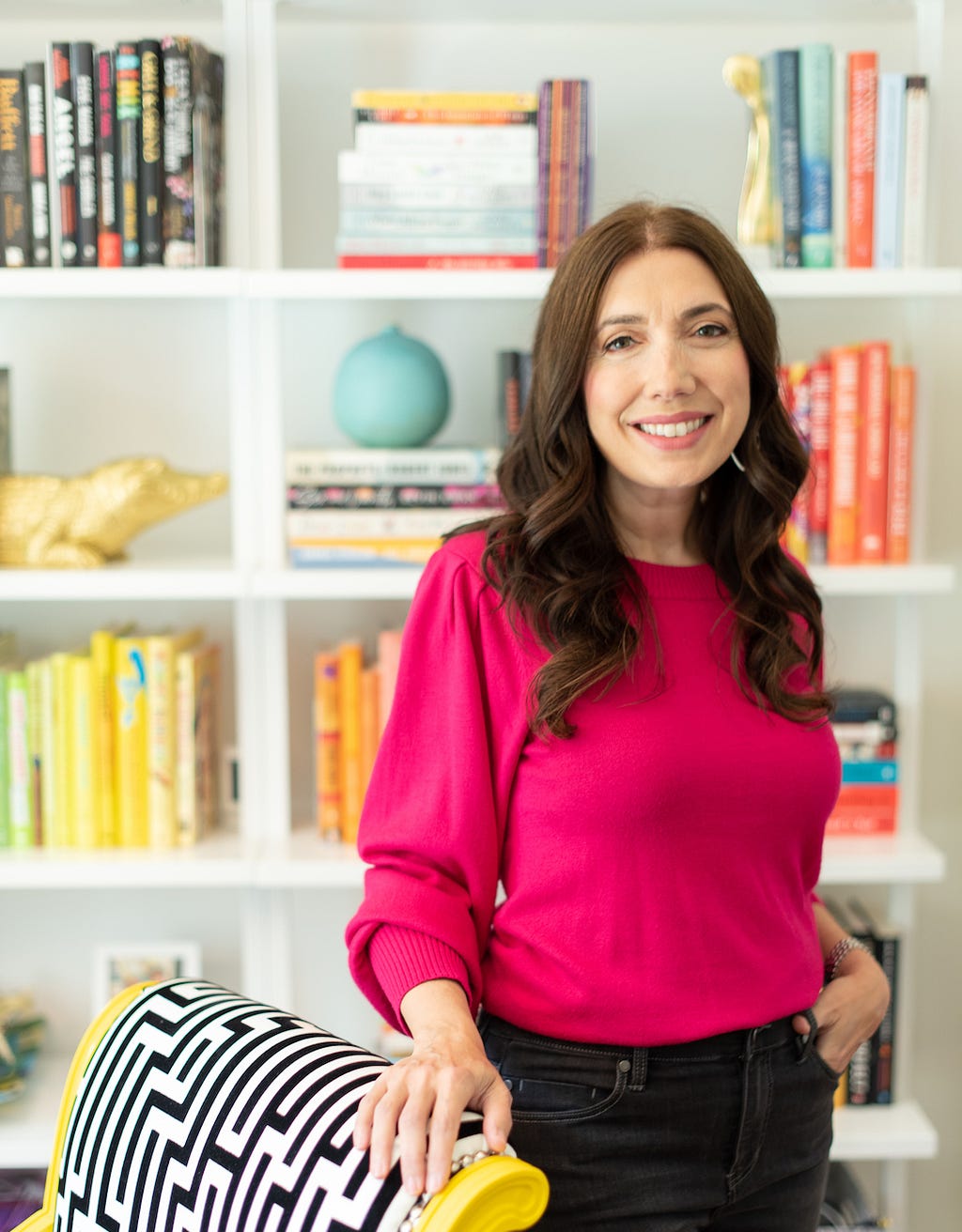 A photograph of author, investor and keynote speaker Fran Hauser standing in front of a bookcase.