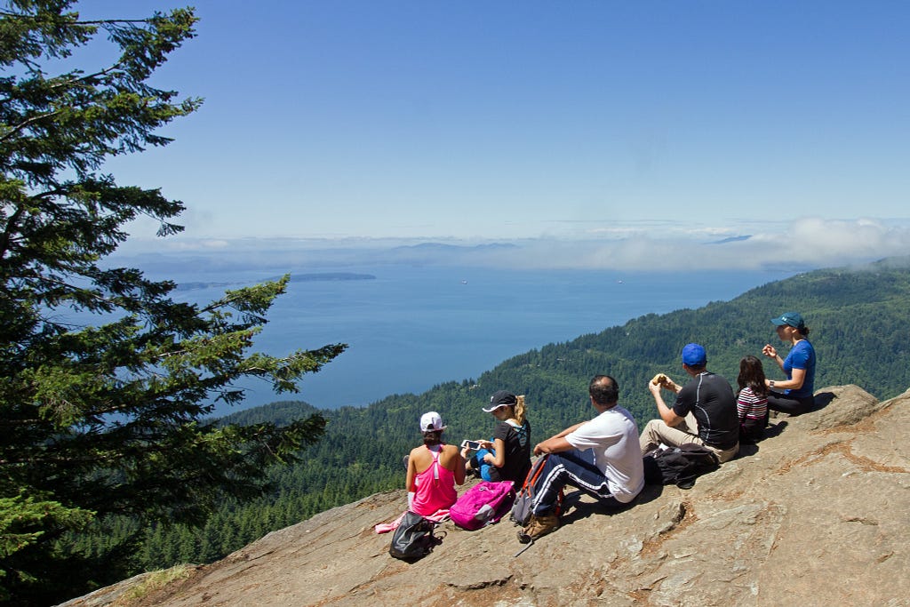 Photo of a group of people enjoying the view from Oyster Dome, near Bellingham, Washington. Photo: Kirk and Barb Nelson