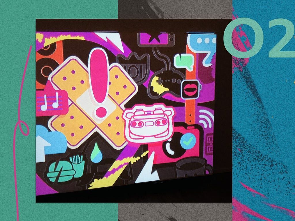 Jimmy projects a full-color iPad drawing of overlapping, icon-like emblems onto his canvas in a dark room.