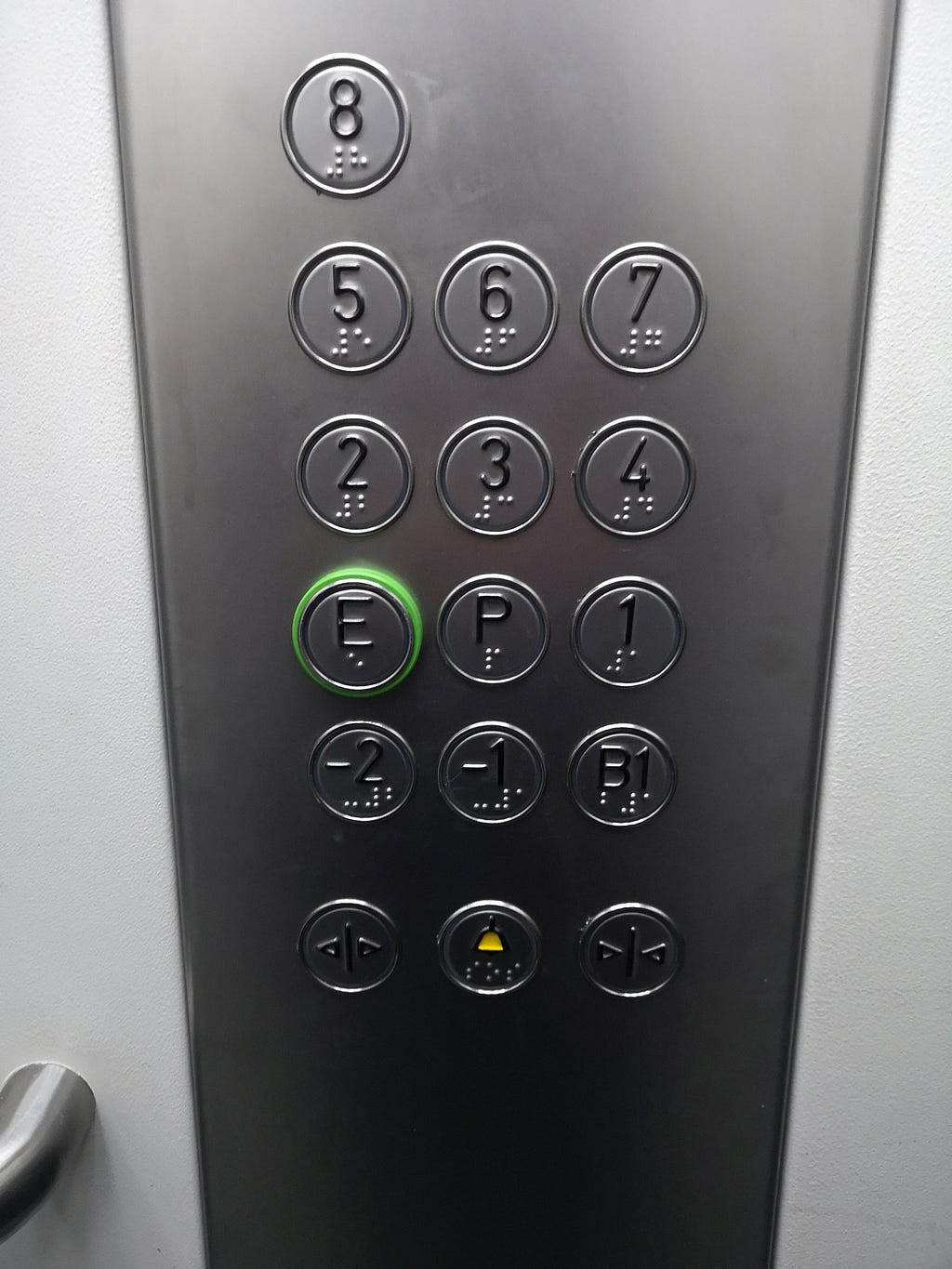 The hotel’s other elevator with buttons in another way. It has an E button to represent the entrance floor and a P button.