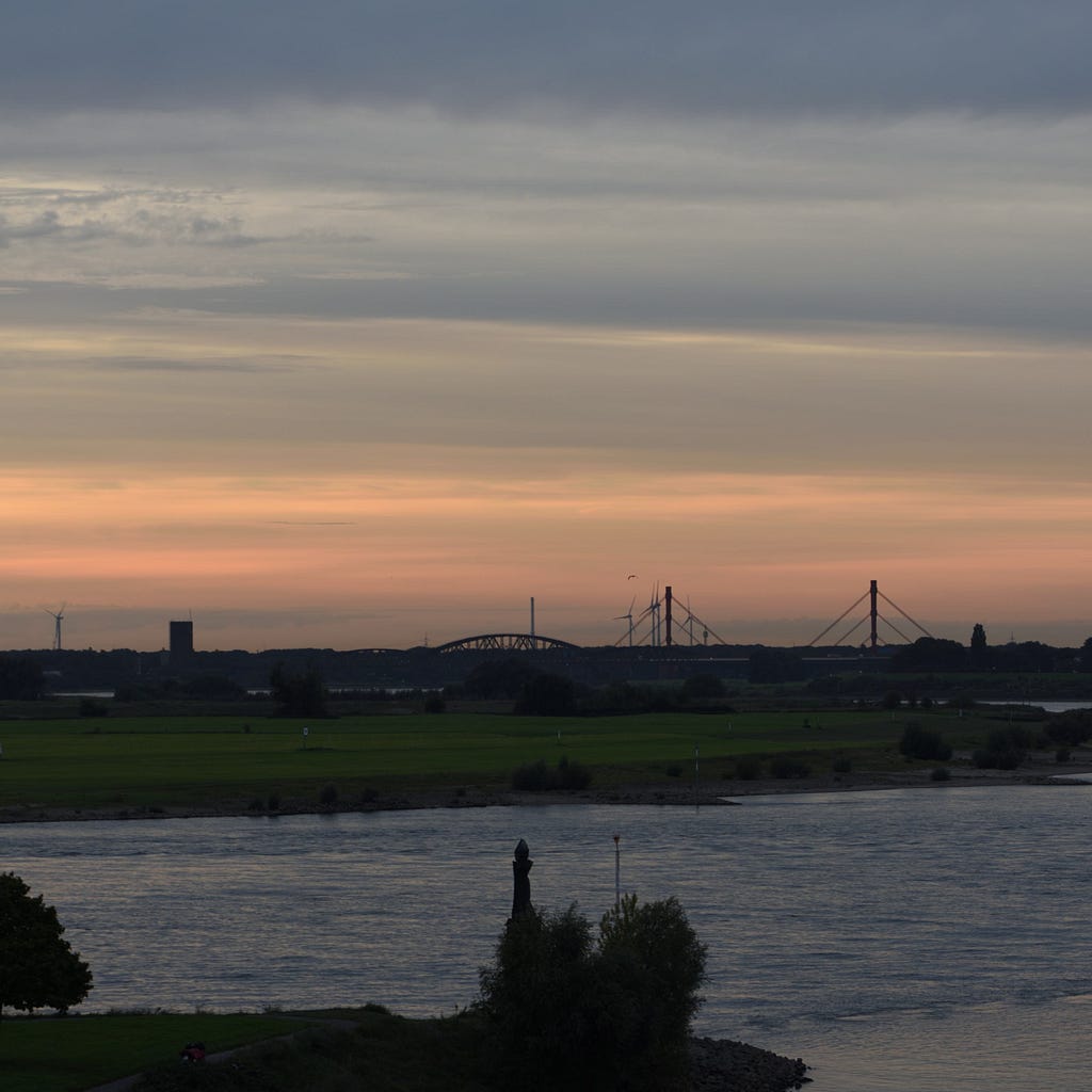 Sunset sky at the Rhine River in Ruhrort. This image was exported from Nikon’s NX Studio software with settings left untouched expect for cropping the portrait frame to a square (meaning: what you see is what the camera would have saved as a jpg). Duisburg, Germany, September 26, 2023.