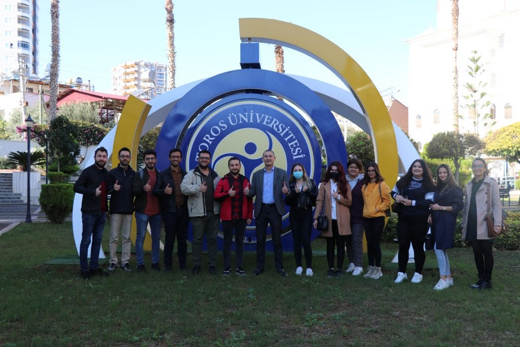 At Toros University located in Mersin, a photograph featuring students and the Chancellor.