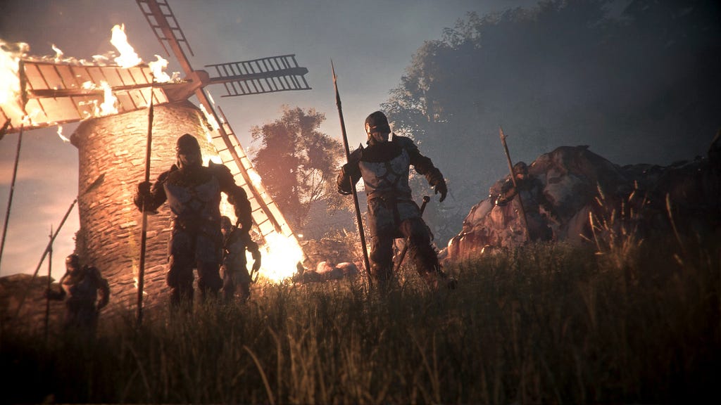 A screenshot from A Plague Tale: Innocence. Armored soldiers stand in a grassy field, holding spears. Behind them, a windmill is on fire.