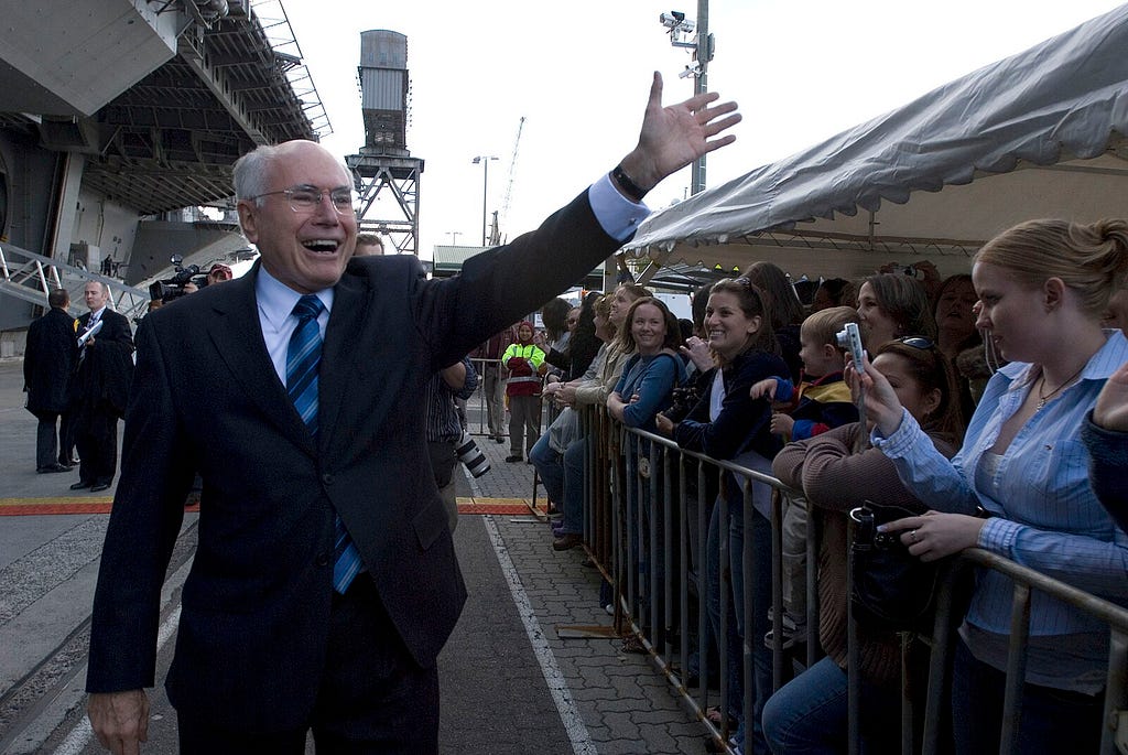 070705-N-8591H-370 SYDNEY, Australia (July 5, 2007) — Australian Prime Minister John Howard greets friends and family members of Sailors aboard USS Kitty Hawk (CV 63). Howard came aboard to tour the ship, to speak with Sailors about the importance of the U.S. and Australian alliance and encourage Sailors to enjoy their time in Sydney. Kitty Hawk pulled into Sydney for a scheduled port visit following exercise Talisman Saber, a joint exercise involving more than 20,000 U.S. and 12,000 Australian