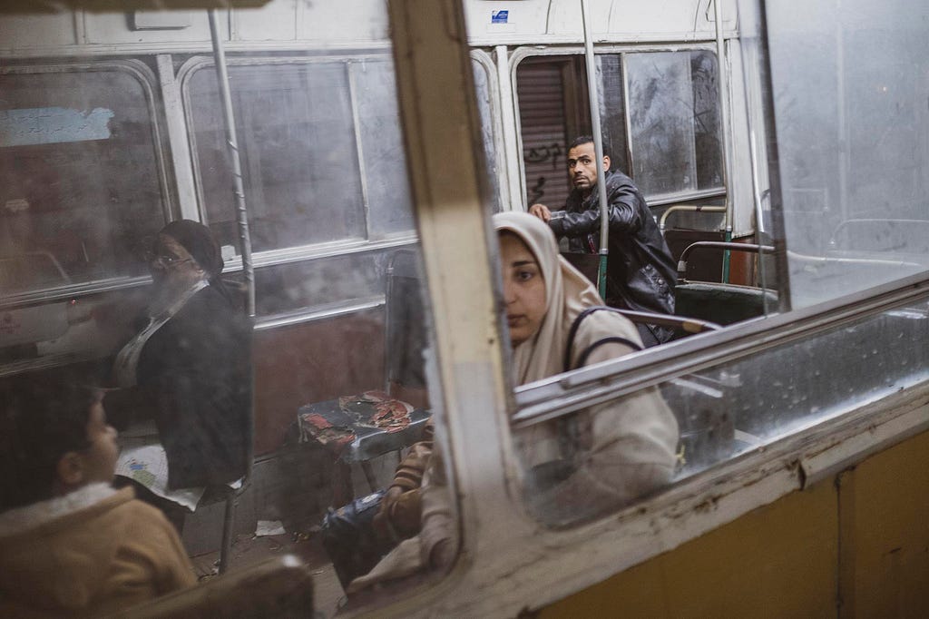 View of unidentified passengers as they sit in a tram carriage, Alexandria, Egypt, March 29, 2019