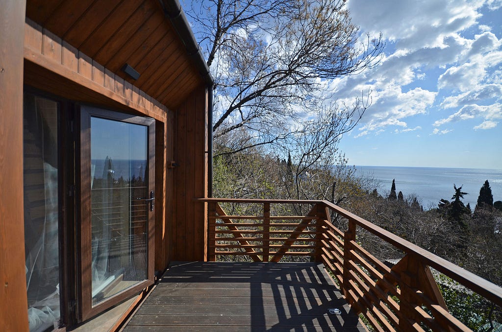 open wood deck with waterfront views