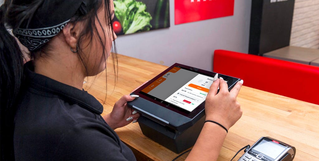 Restaurant staff member using the redesigned Orderpad restaurant app