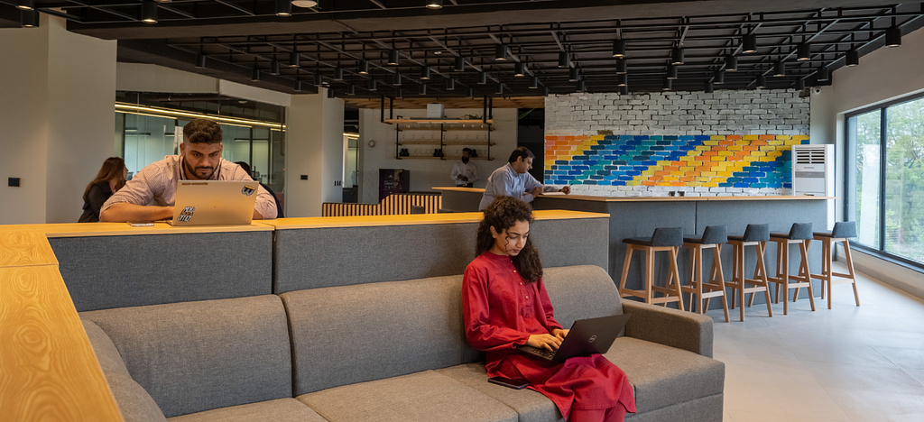 A man and a woman working on their laptops at Daftarkhwan | Downtown.