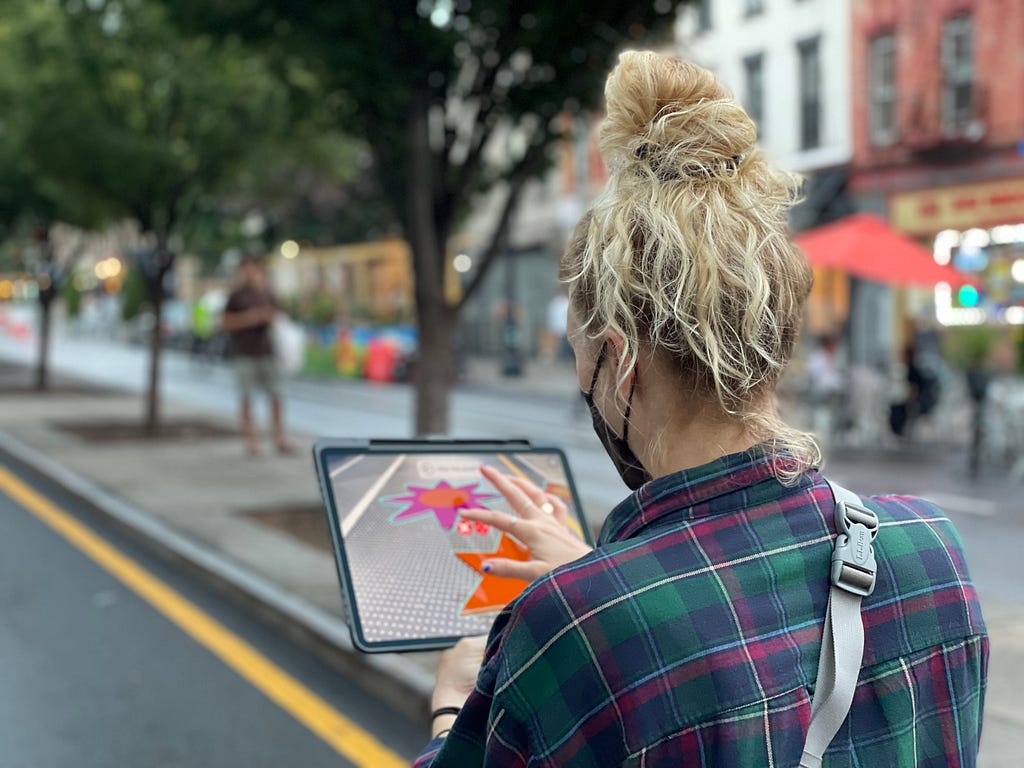 A woman uses the YARD augmented reality app on an iPad