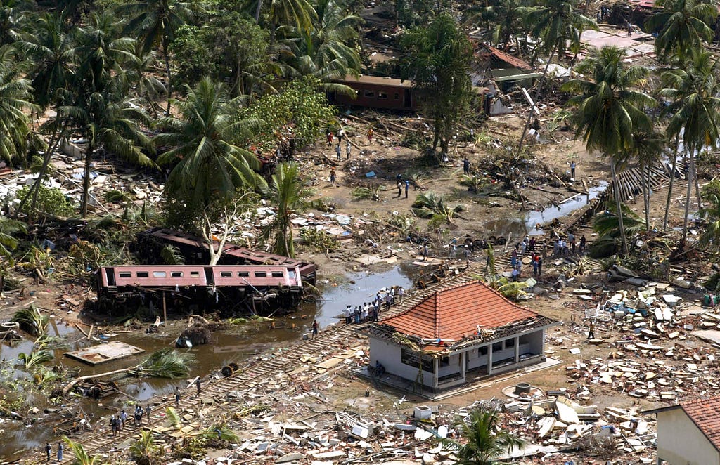 An aerial photo taken in Sri Lanka after the 2004 Indian Ocean tsunami that killed more than 225,000 people across a dozen countries. Rich Girven, now a senior researcher at RAND, was serving as the defense attaché in Sri Lanka then and spent days surveying the devastation. Photo by Vincent Thian/AP