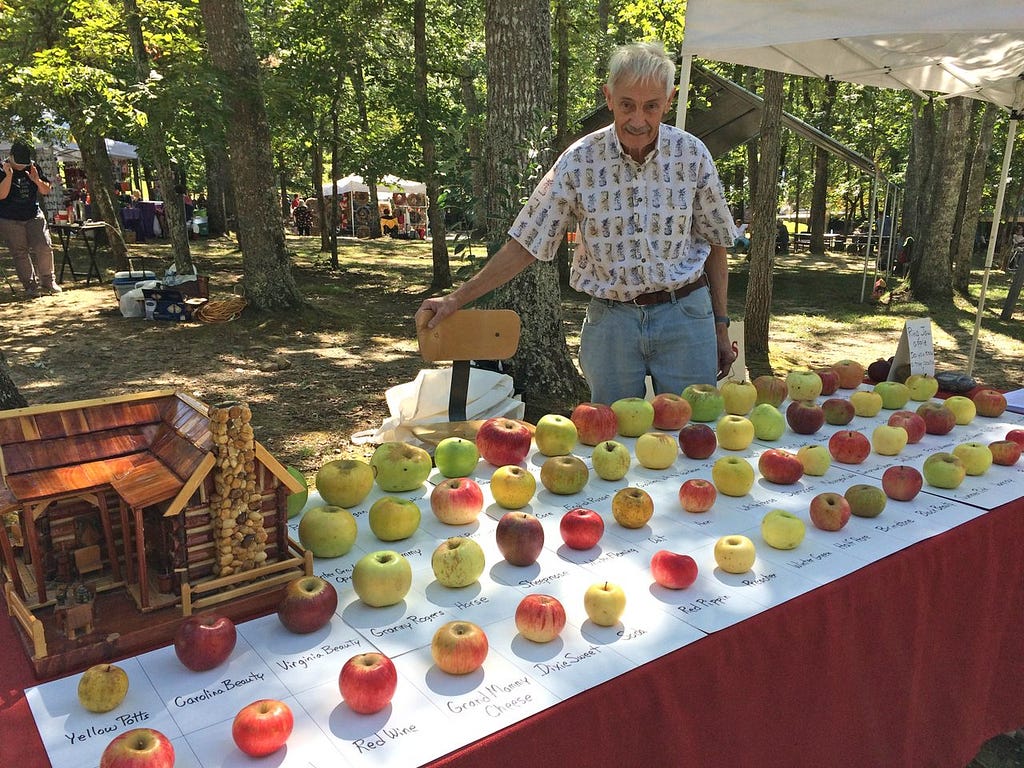 Tom Brown, an Appalachian farmer, pictured with dozens of different lost apple varieties that he rediscovered.