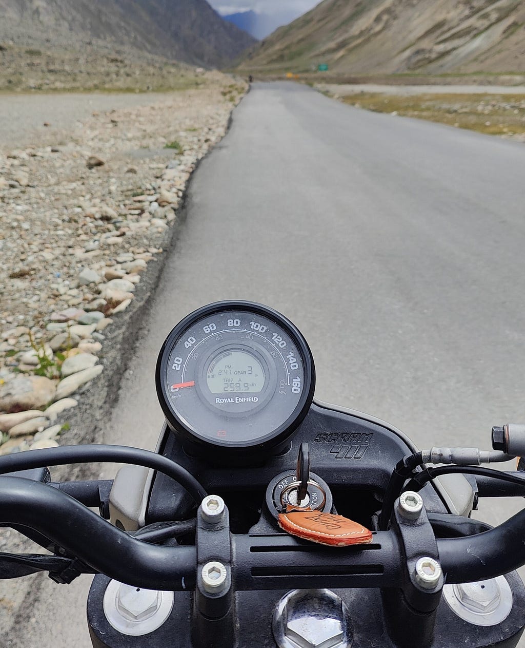 A picture of Aishwarya’s motorbike with the speedometer in focus and a highway in sight.