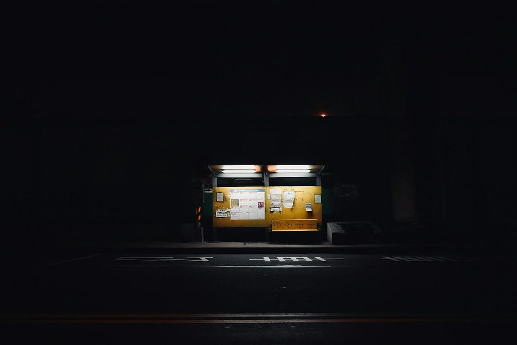 Illuminated Bus Stop at Night