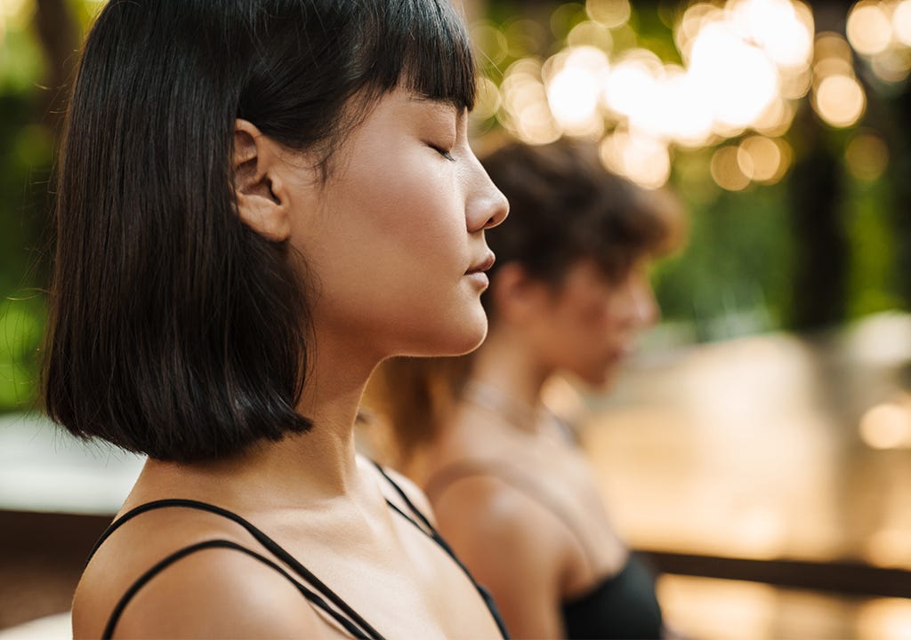 woman close her eyes in mindfulness meditation