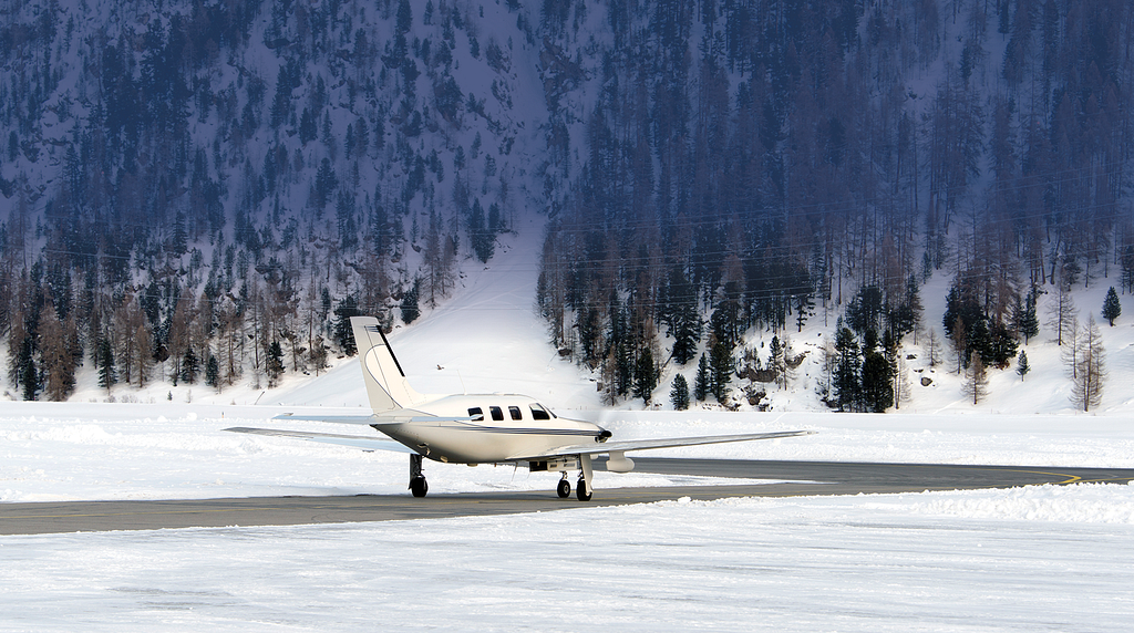 Photo of an airplane on a snowy taxiway.