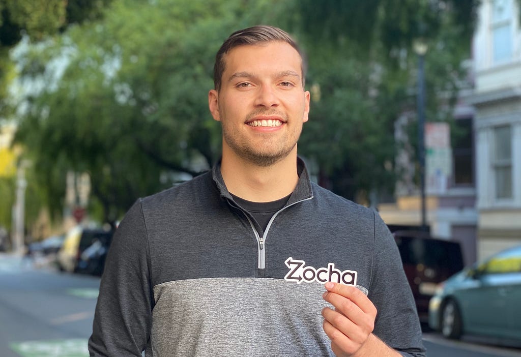 Mitch Patin holding a Zocha sticker