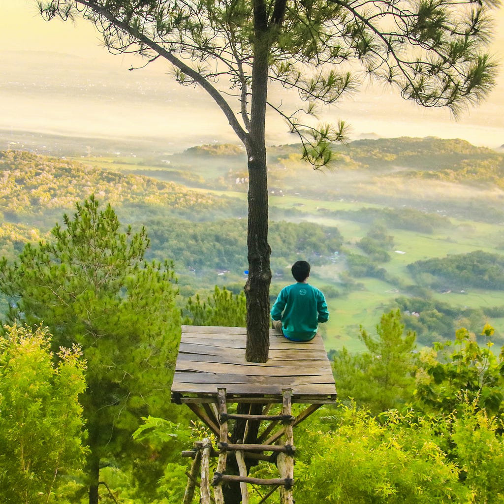 A man meditating in a serene environment