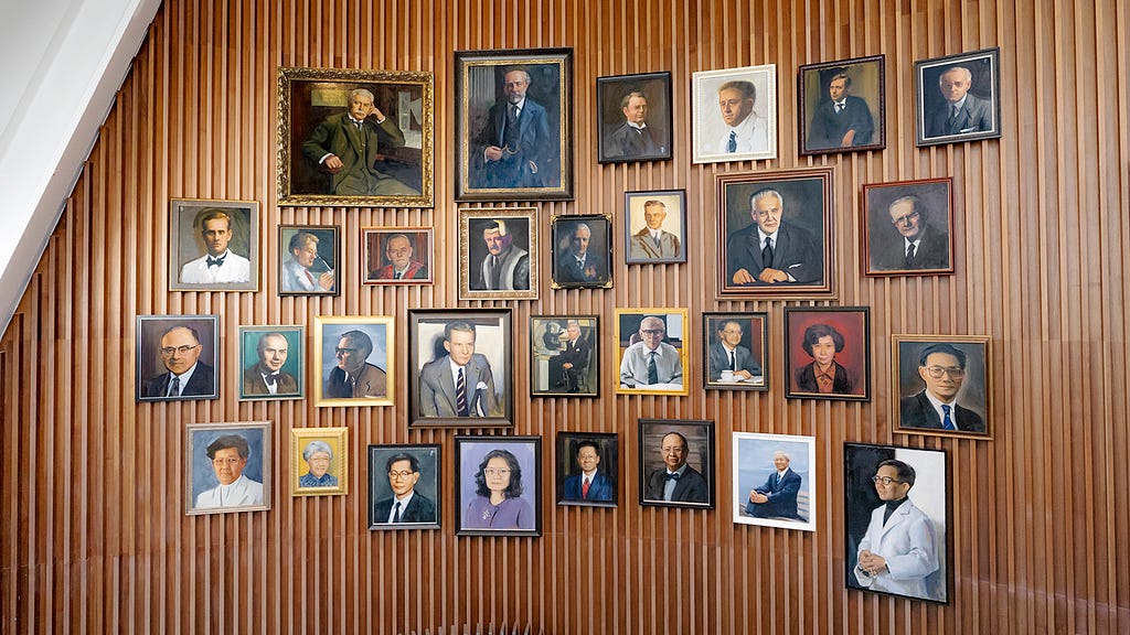 Oil portraits of HKUMed’s 31 current and former deans hang on a curved wall