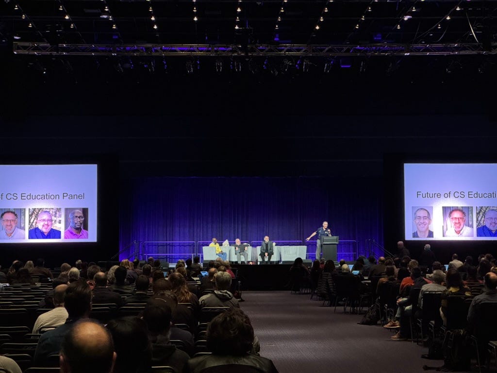 Dan Garcia congratulating Jonathan Mwaura, Mitch Resnick, and Manual Pérez-Quiñones on stage.