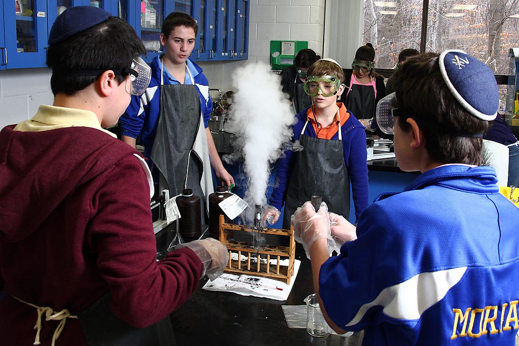 Science experiment in class, with white plume as the center of attention (Judah S. Harris)