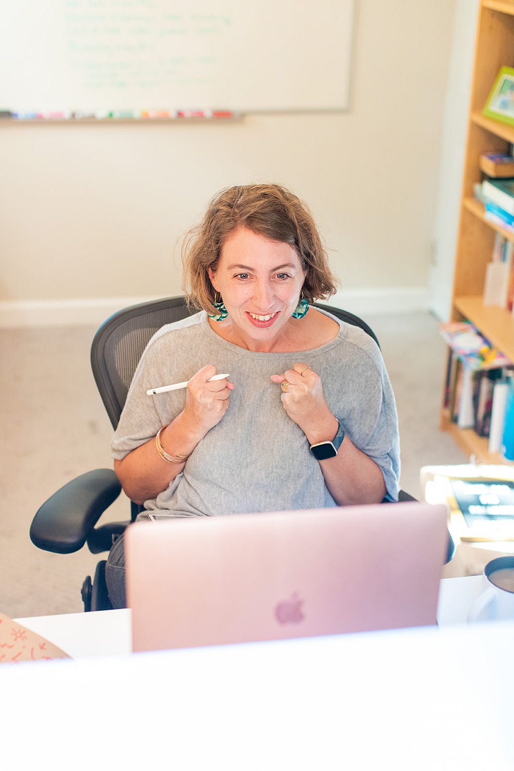 Jen Dary, the author of this article, coaches via laptop with an excited look.