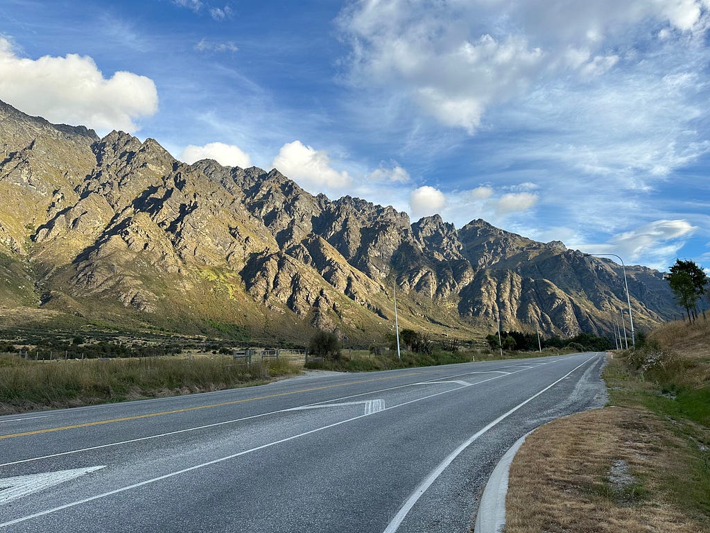 The Remarkables mountain range with road in front.