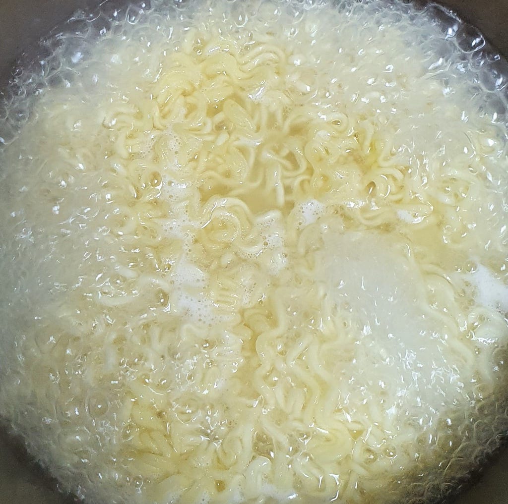 The noodles cooking for 4 minutes and 30 seconds for a package of Wicked Ramen (Yogoe Ramyeon) Shinsadong Naengcho-Myeon Flavor.