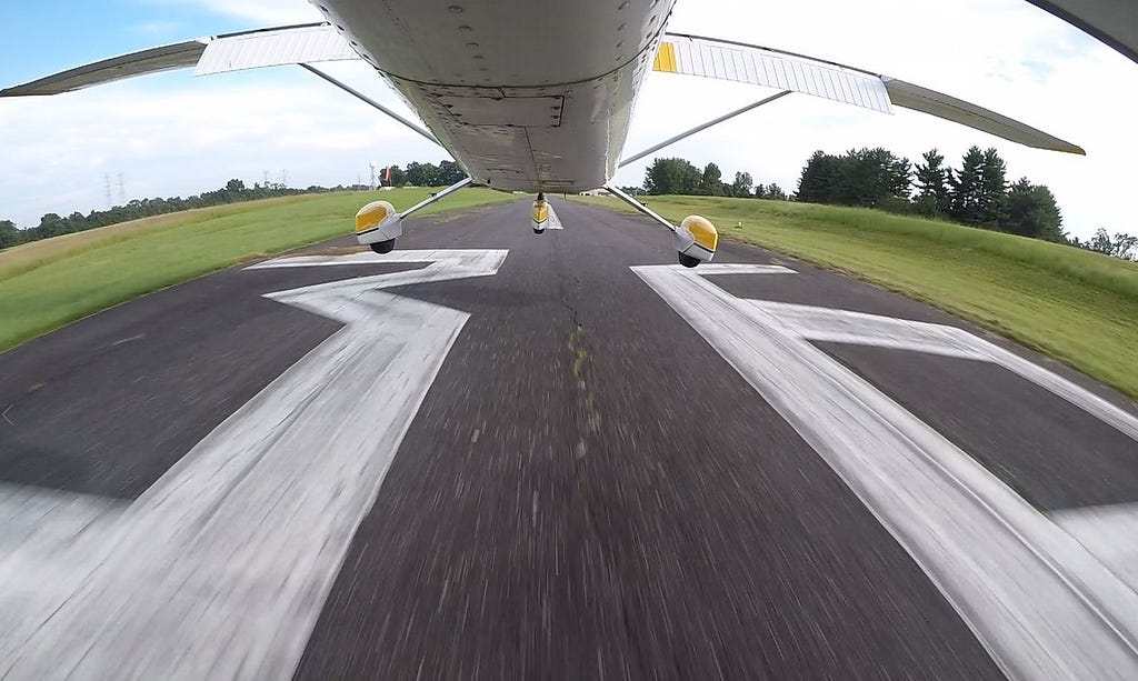 The undercarriage of a plan mid-landing.