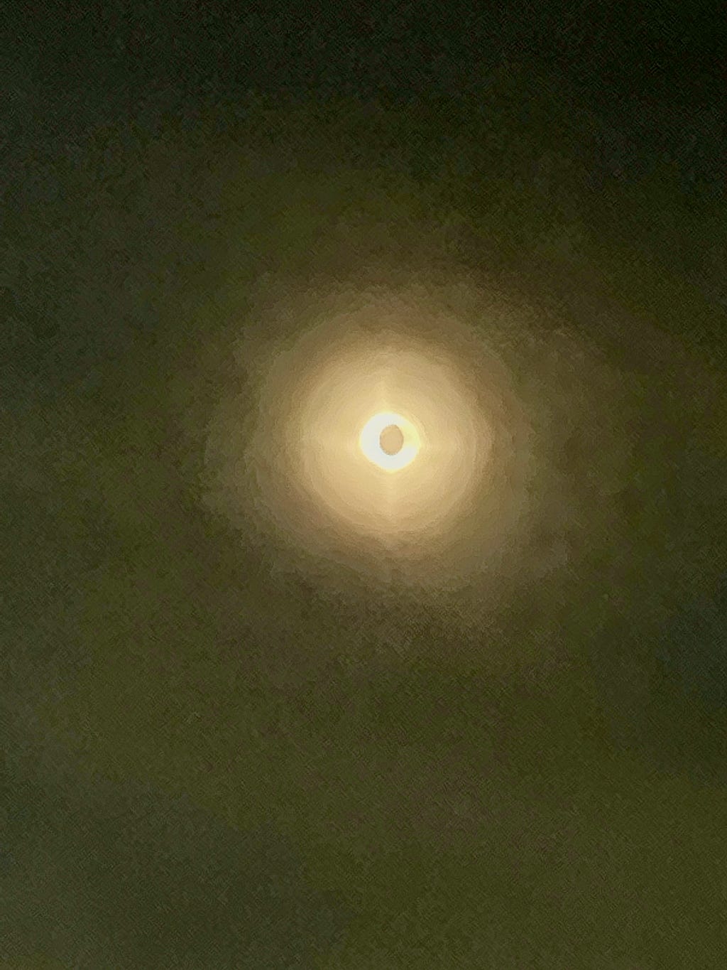 A photograph of the solar eclipse simultaneously showing the dusk and dawn as the moon is perfectly centered in front of the sun.