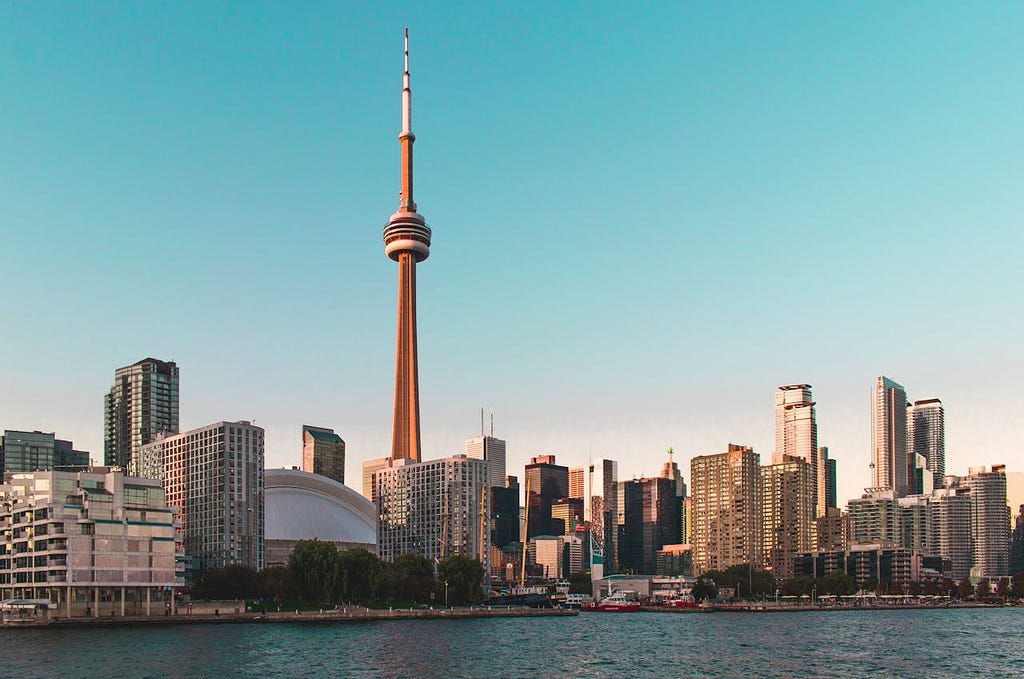 Plenty of High Rise Buildings with CN Tower Under Blue Sky near the Lake Ontario in Toronto