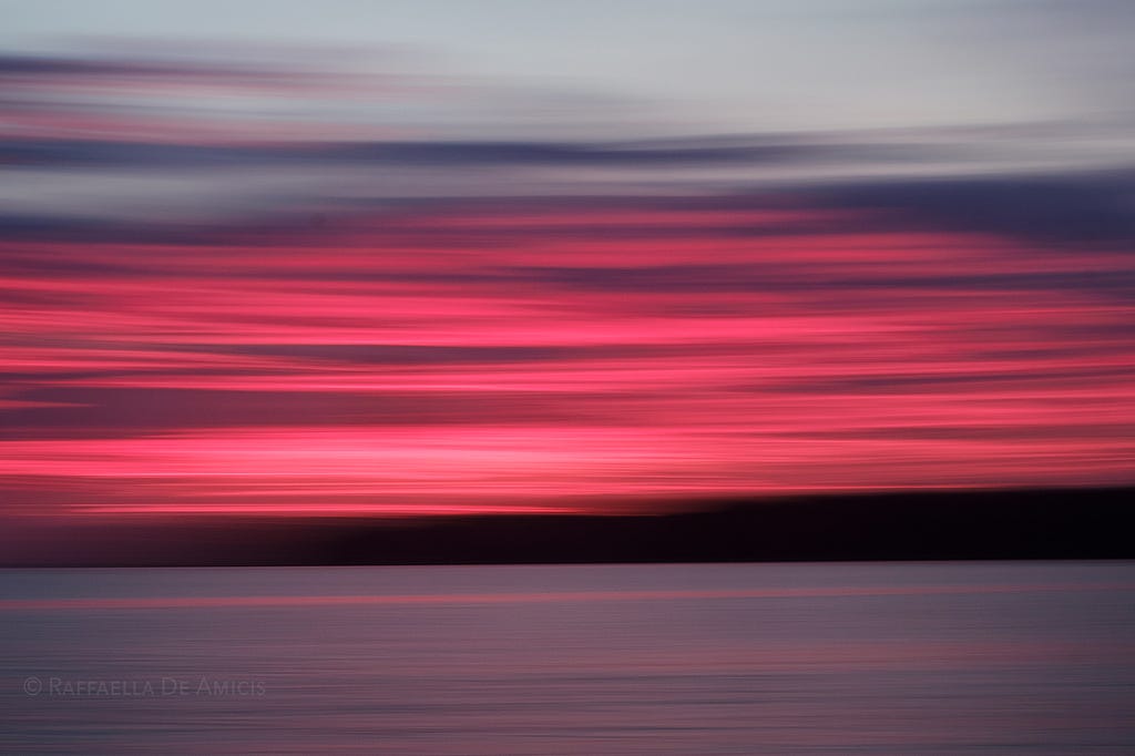 neon sunset colors over the ocean in abstract motion