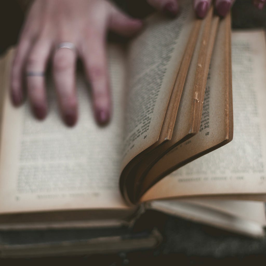 hands turning the pages of a book