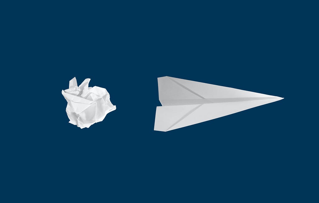 Image of a crumbled ball of paper and a paper airplane