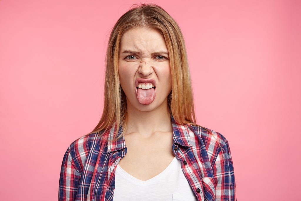 Girl sticking her tongue out in disgust